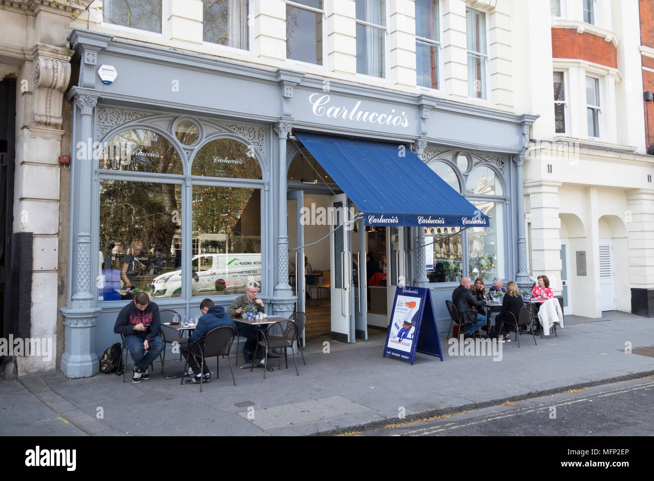 People eating outside Carluccio's Italian restaurant, West Smithfield, London, EC1, UK Stock Photo