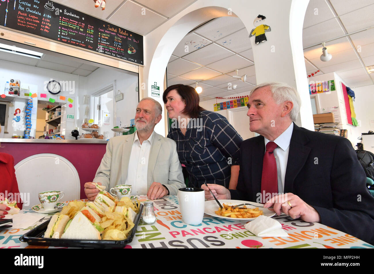 Labour leader Jeremy Corbyn and shadow chancellor John McDonnell having a bit to eat while canvassing in the Com.Cafe. West Drayton, London ahead of the local elections. Stock Photo