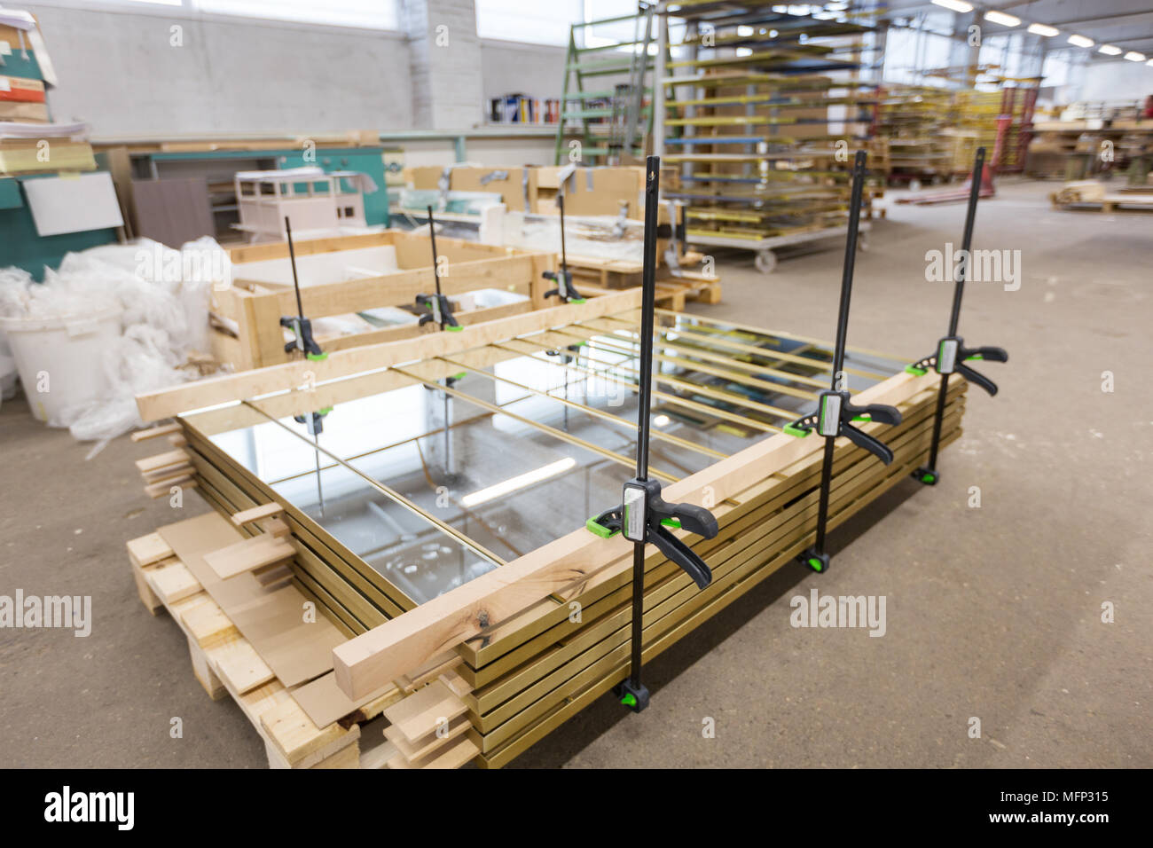 mirror panels with bar clamps at furniture factory Stock Photo