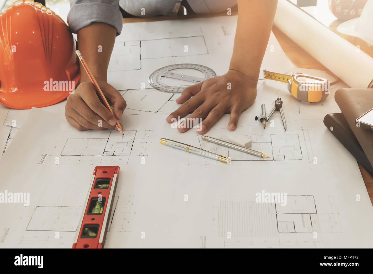Architect or engineer working on blueprint, architectural concept Stock Photo