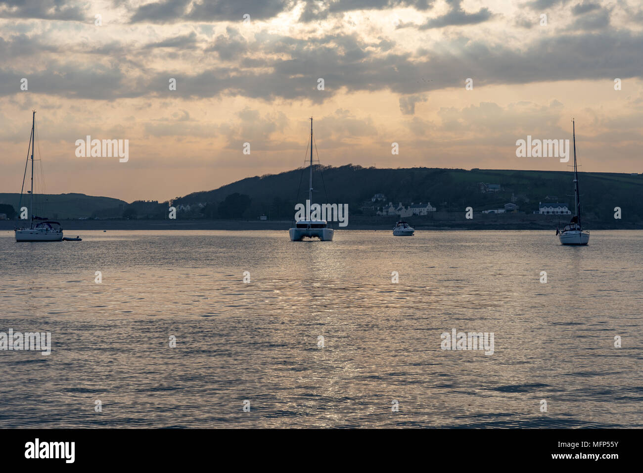 Sailing yachts and motor boats anchored at Dale Pembrokeshire on a spring evening Stock Photo