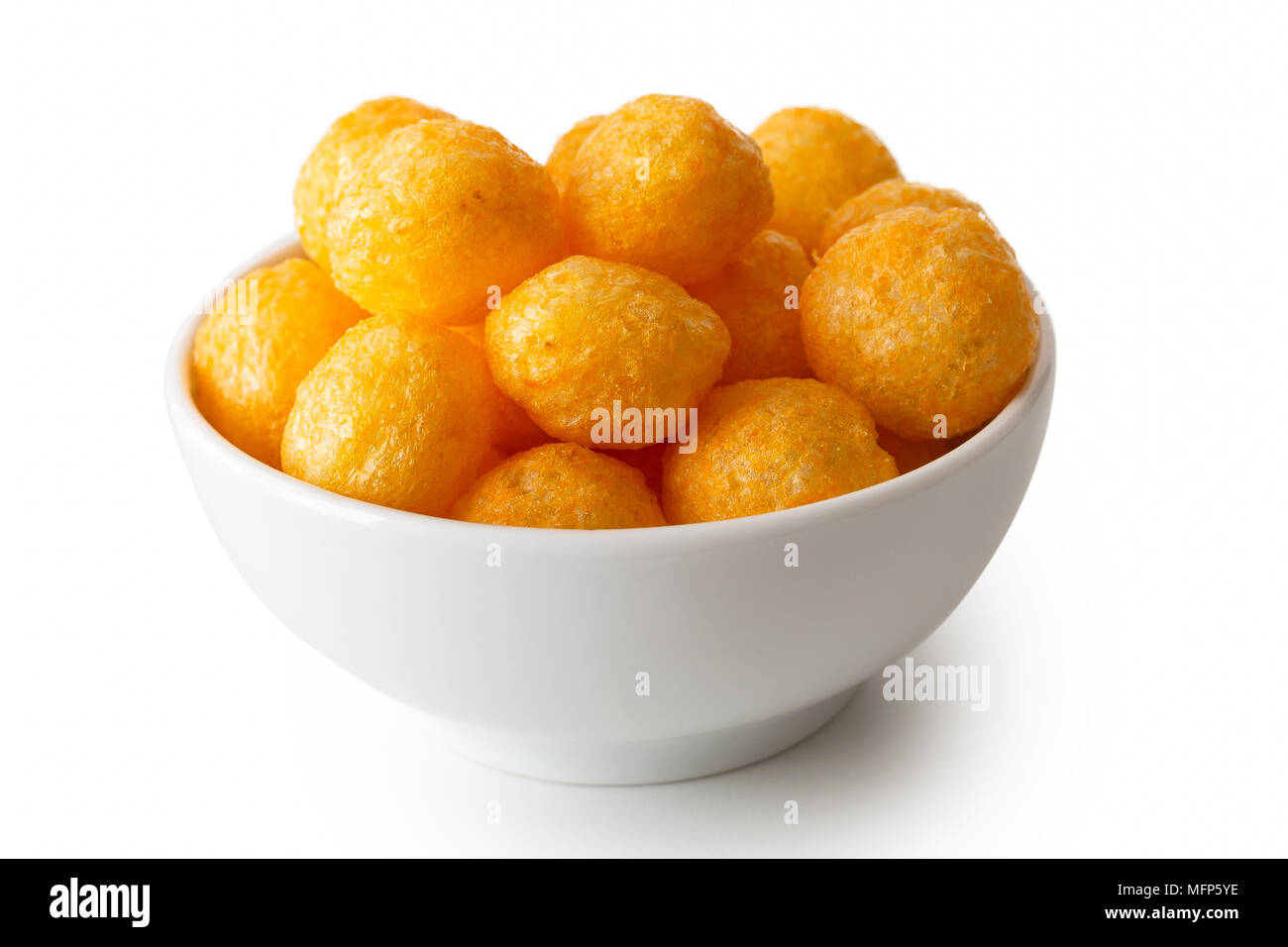 Extruded puffed cheese balls in white ceramic dish isolated on white. Stock Photo
