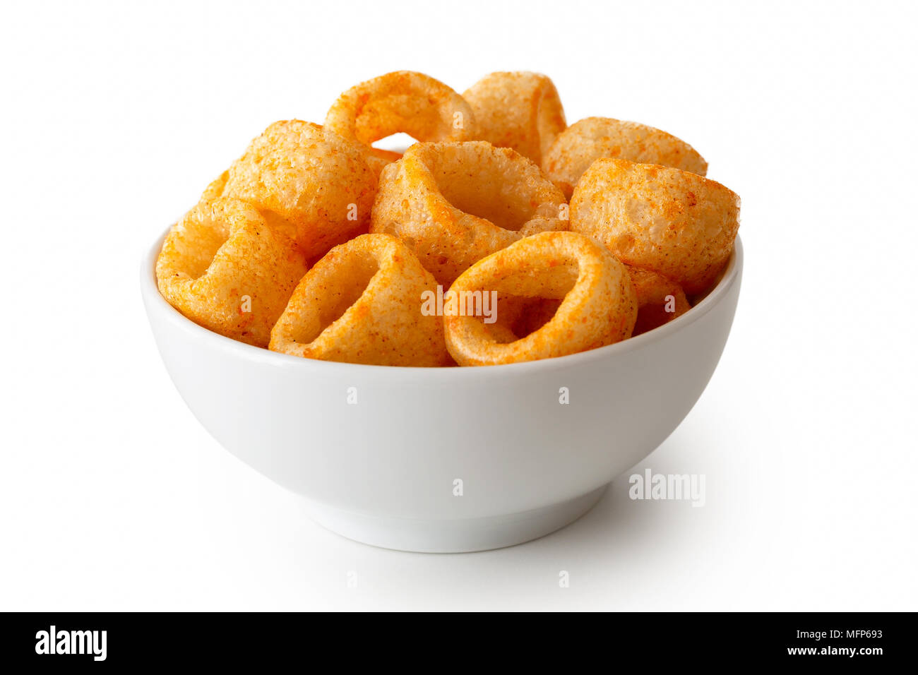 Extruded ring puff corn snack in white ceramic dish isolated on white
