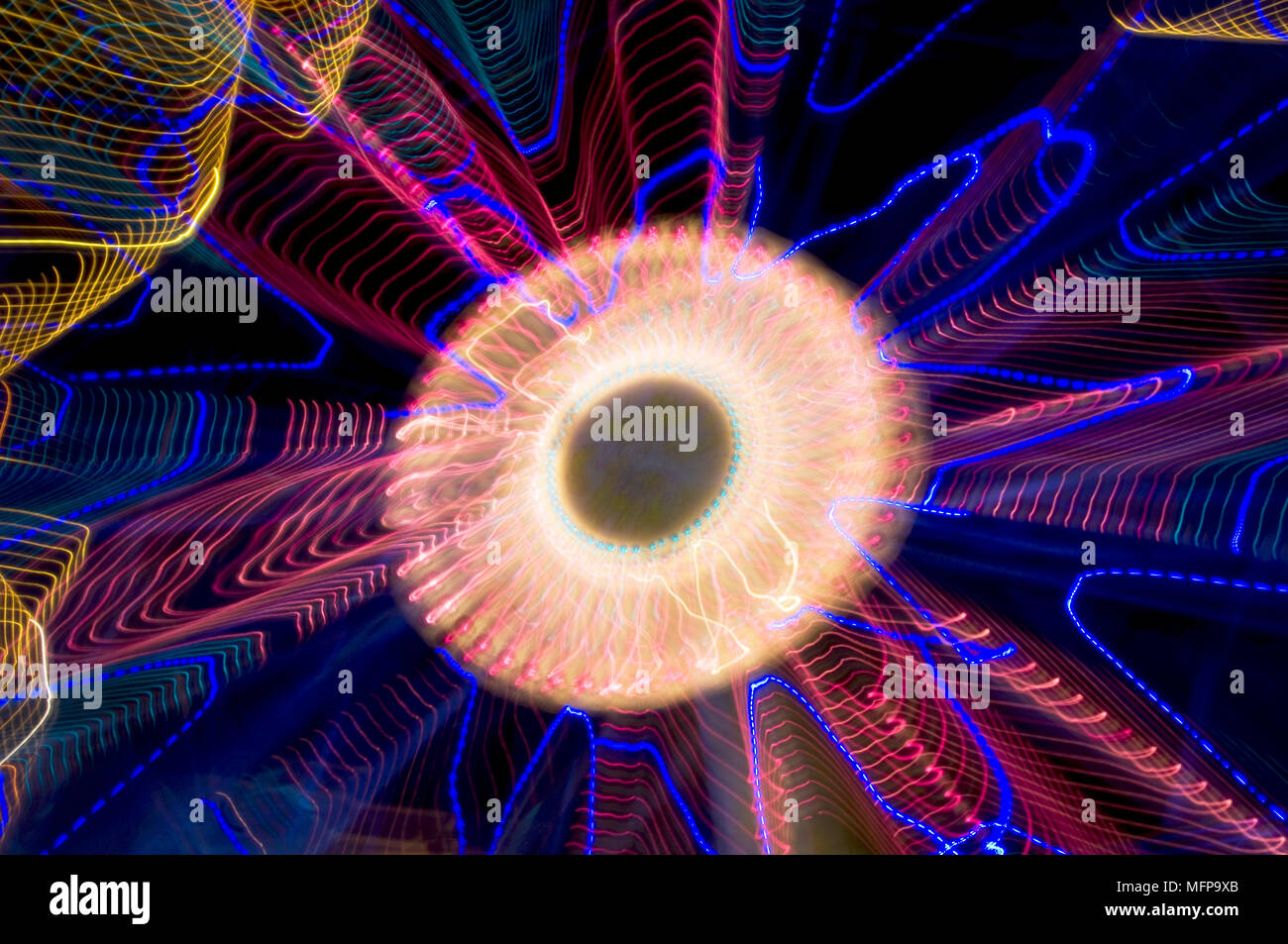An energetic abstract of the lights of a fairground ferris wheel at