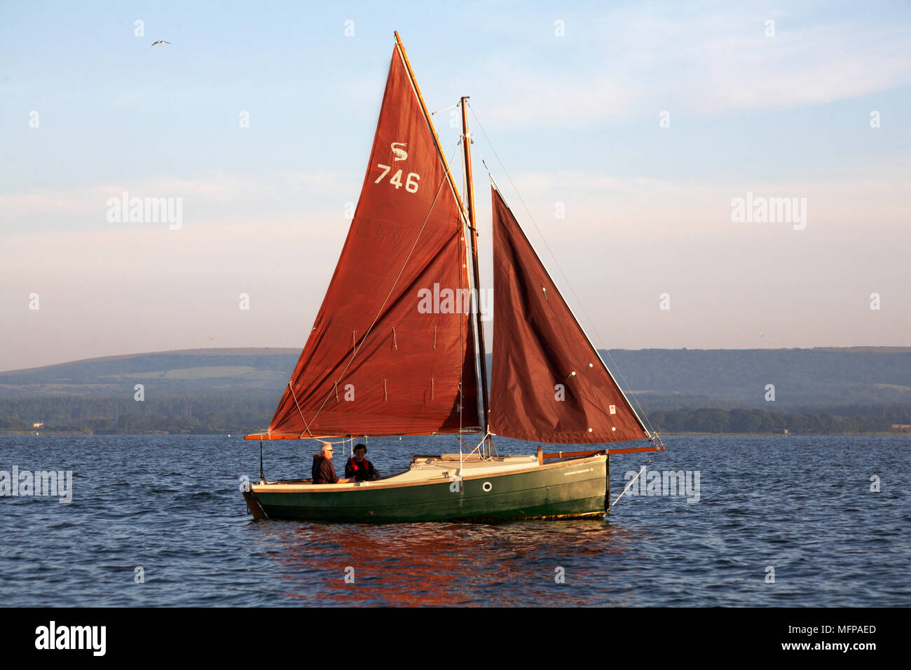 sailing around Poole Harbour in a Cornish Shrimper boat in summer Stock Photo Alamy