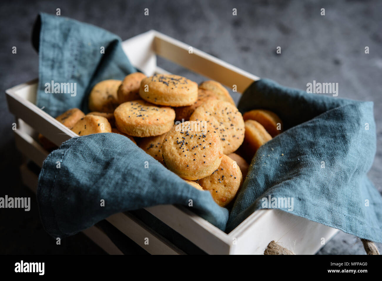 Baked savory Cheddar cheese crackers sprinkled with poppy seeds Stock