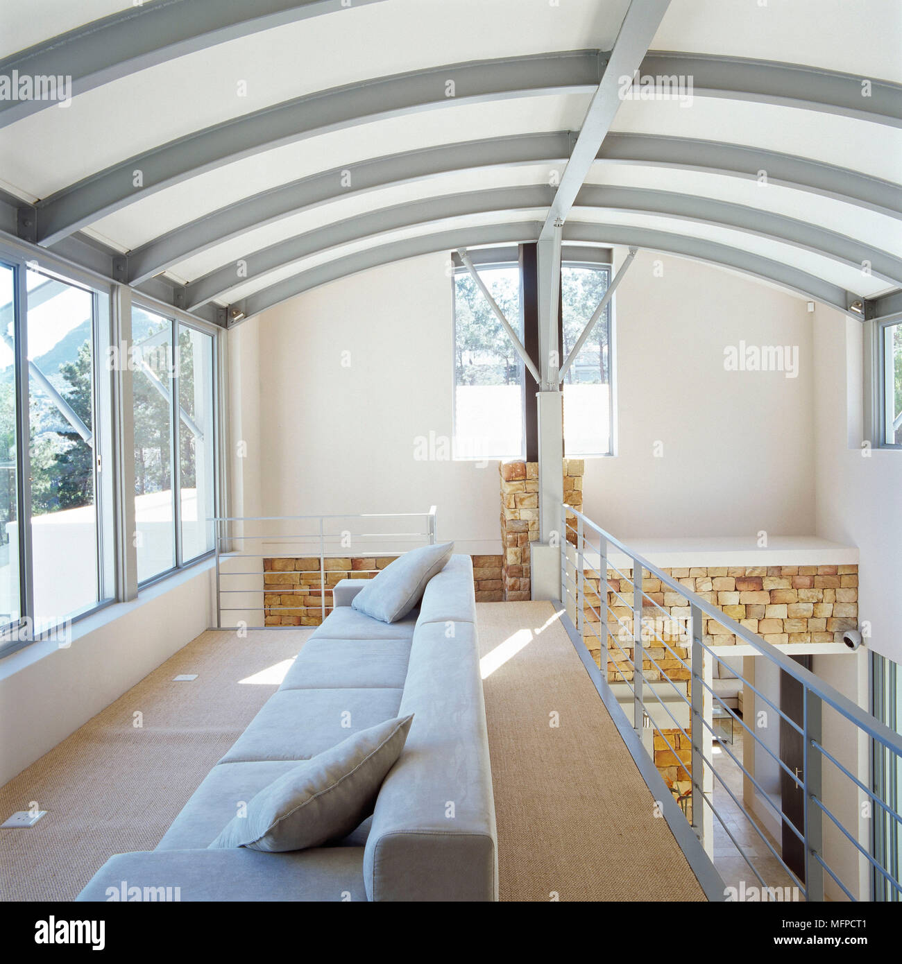 Sofa In Mezzanine Floor Of Modern House With Curved Ceiling