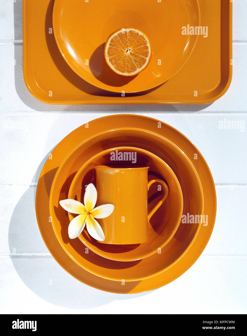 Vibrant orange plastic tableware Stock Photo