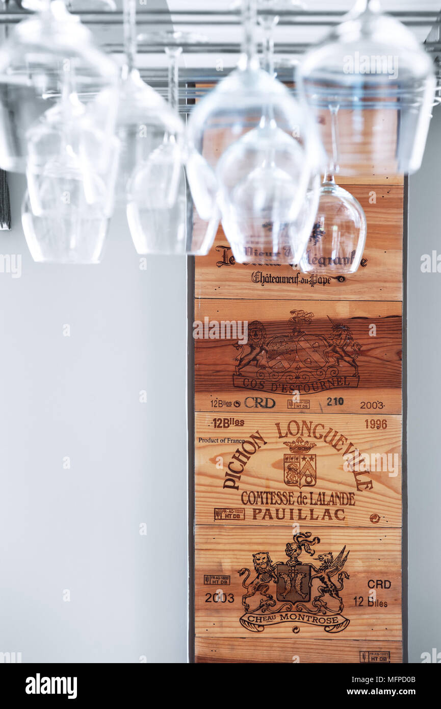 Wine glasses stored upside down in stainless steel grill with recycled