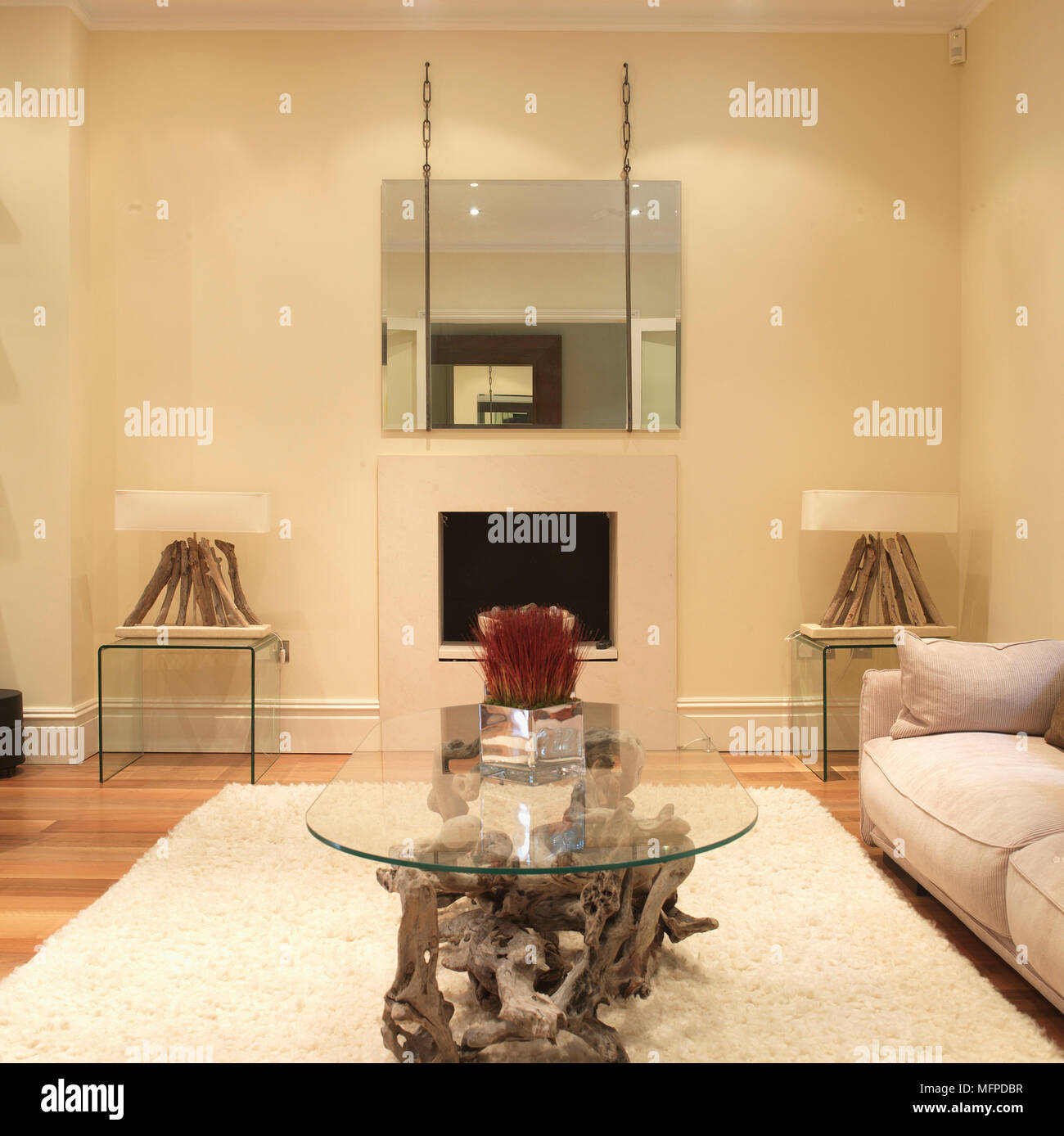 Coffee Table Made From Glass Top On Driftwood On White Rug In Contemporary Sitting Room Stock Photo Alamy