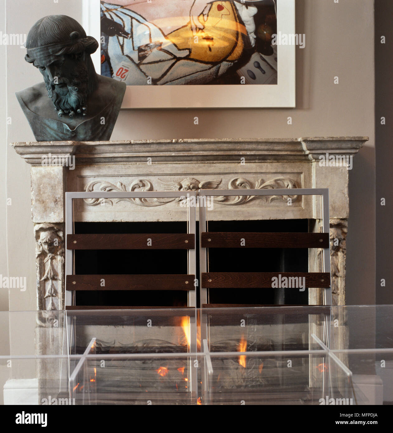Perspex table and chairs in front of fireplace Stock Photo