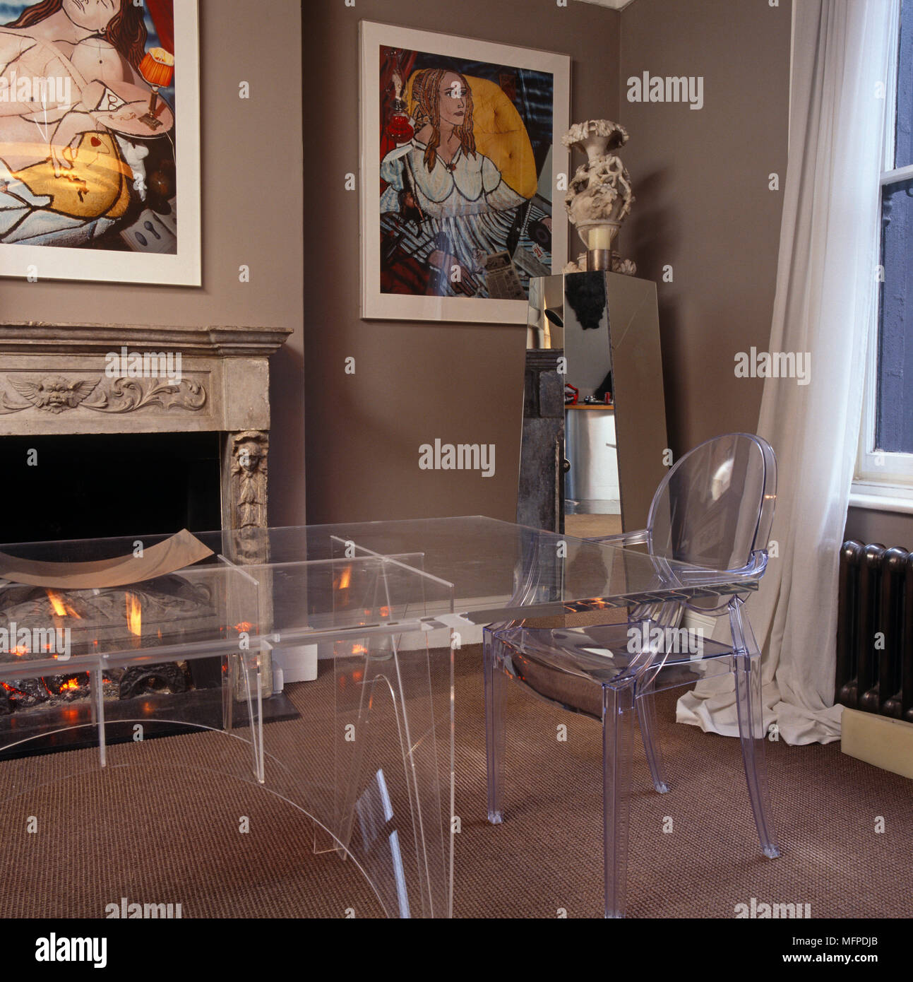 Perspex table and matching Philippe Starck ÔLouis GhostÕ chairs Stock Photo