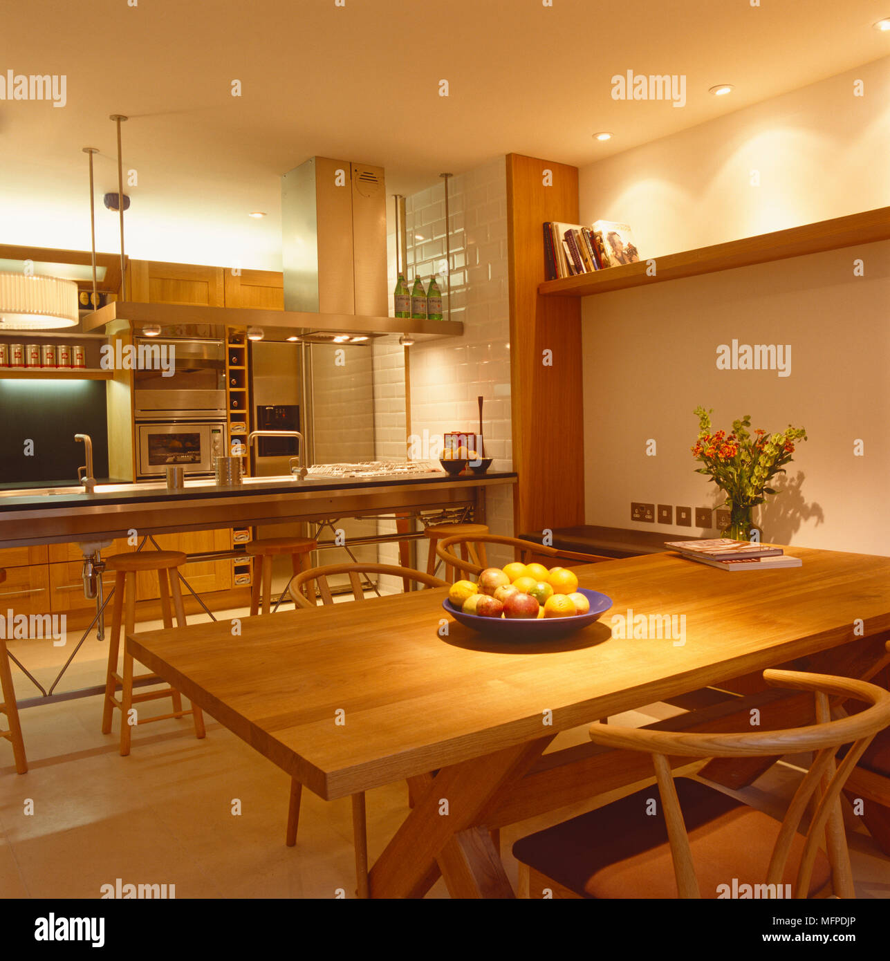 Kitchen with wood cabinets and a dining table and chairs Stock Photo ...