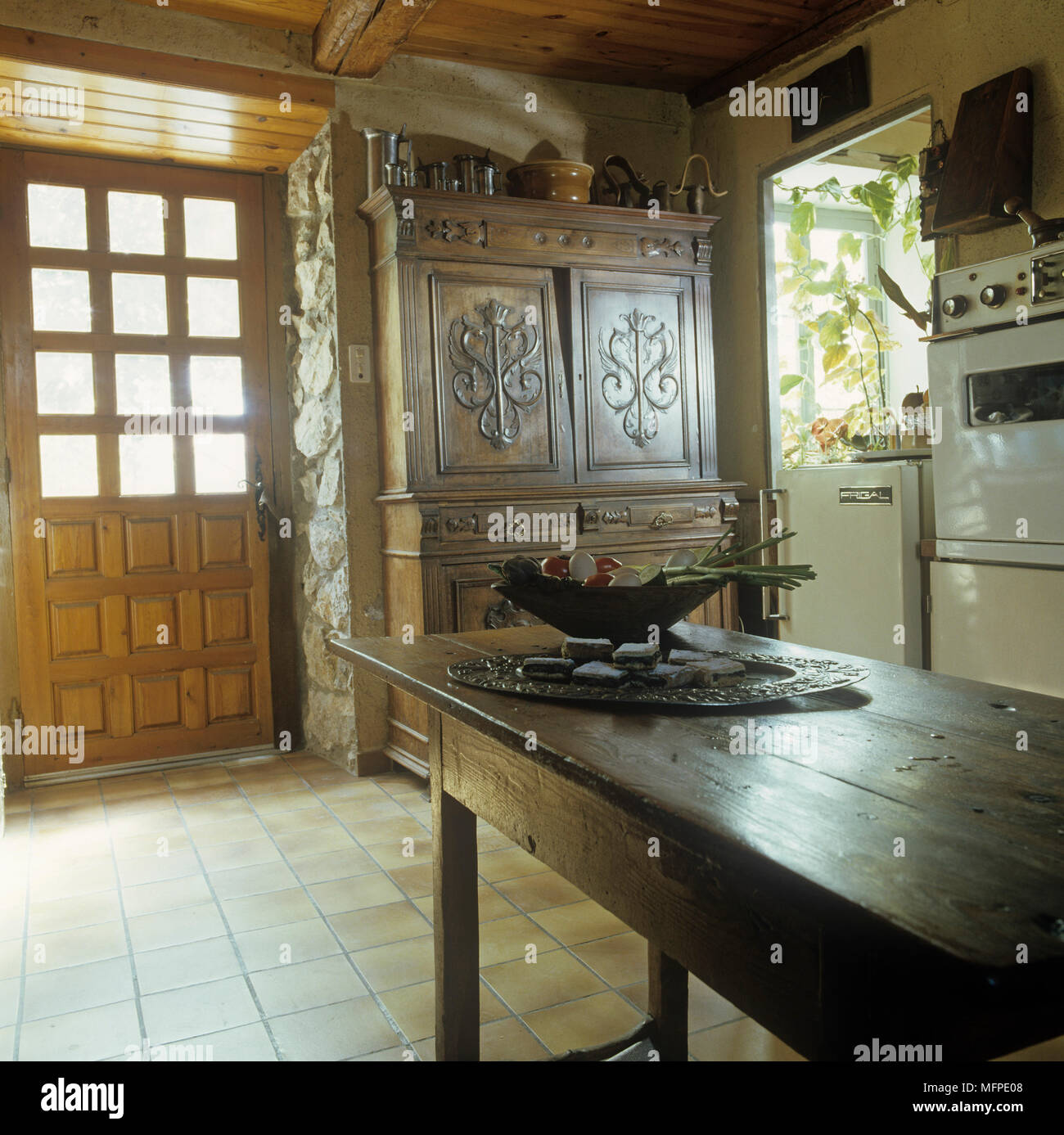 Oak table and cabinet in country style room Stock Photo - Alamy