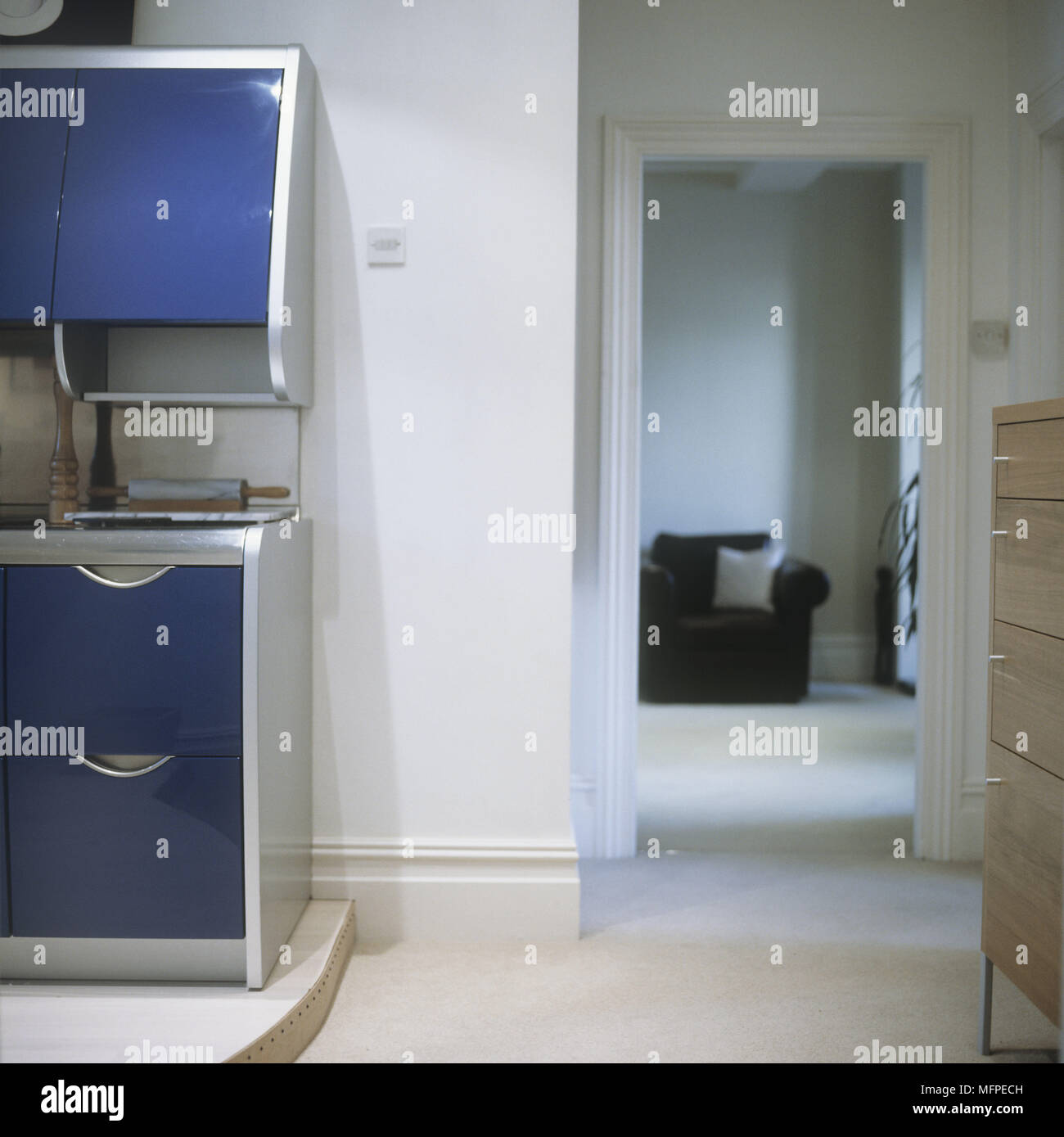 Detail of a modern kitchen door open to sitting room Stock Photo