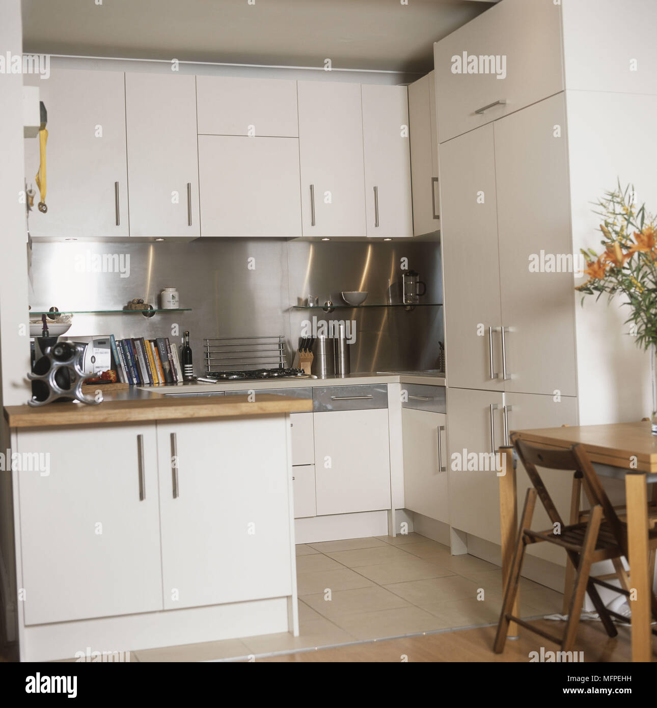 Overview of a modern kitchen white units dining table Stock Photo Alamy