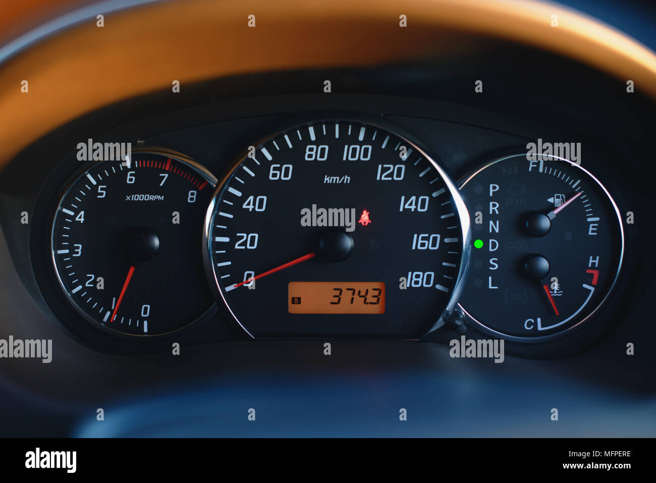 Car dashboard with speedometer and tachometer in black color, close up