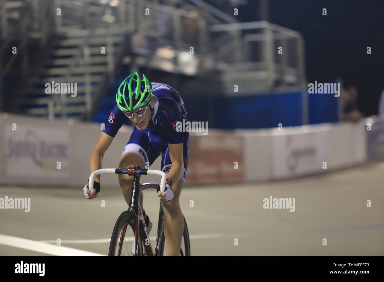 Head down and gasping for air, a solo bicycle racer drives for the finish line, Lehigh Valley Cycling Center, Pennsylvania, USA Stock Photo