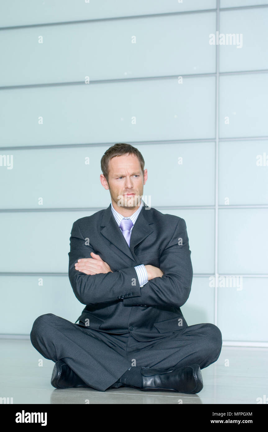 Businessman sitting with his arms crossed   Ref: CRUSC 10020 023  Compulsory Credit: Staurt Cox / Photoshot Stock Photo