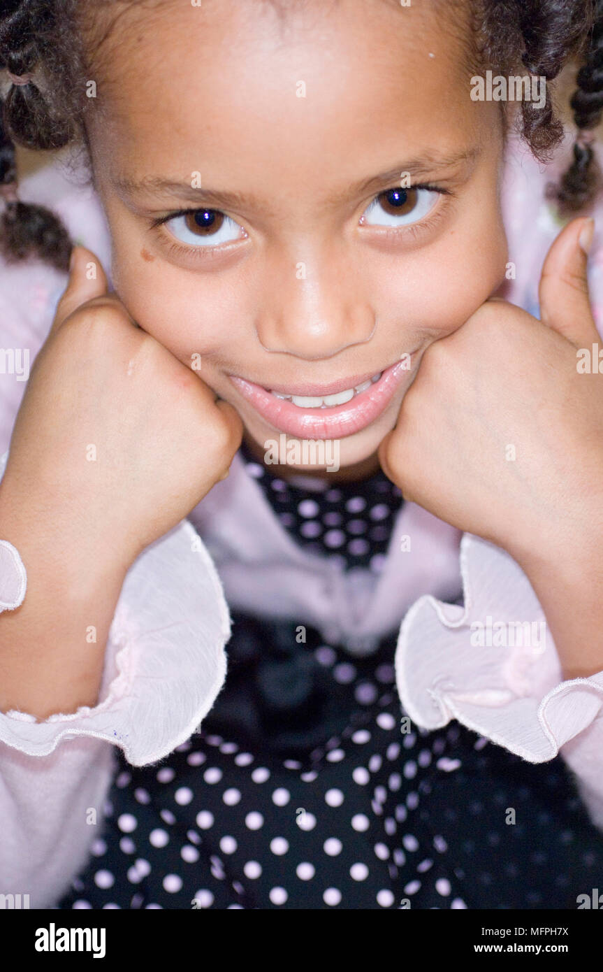 Portrait of a girl smiling with her head in her hands Ref: CRUSC 10032 ...