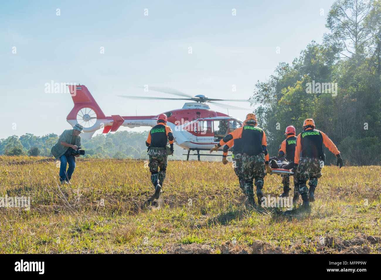 Nakhon Ratchasima, Thailand - December 23, 2017: Rescue team carrying injured passenger to helicopter to hospital in rescue drill on simulation of pas Stock Photo