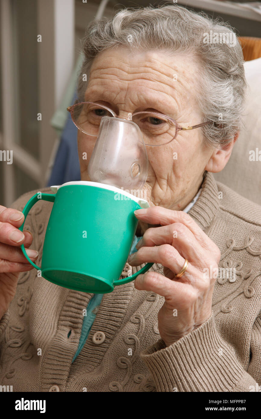 Elderly woman using a steam inhaler inhaling a decongestant for colds &  bronchitis model release Stock Photo - Alamy