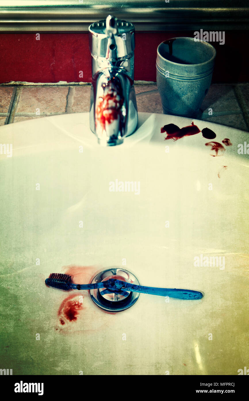 Sink with faucet and bloody toothbrush Stock Photo