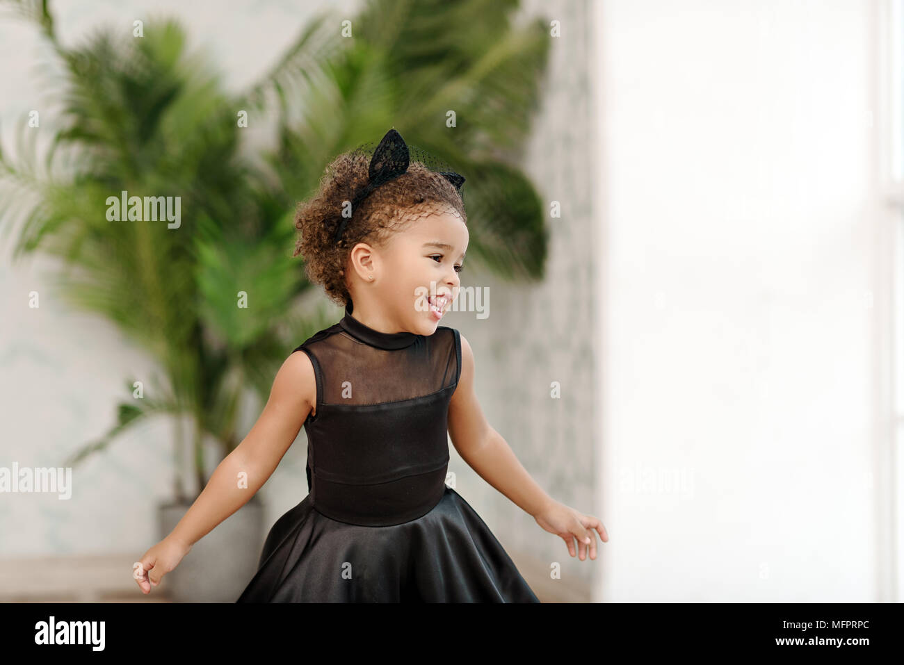 Girl sitting still and looking at camera with open eyes Stock Photo - Alamy