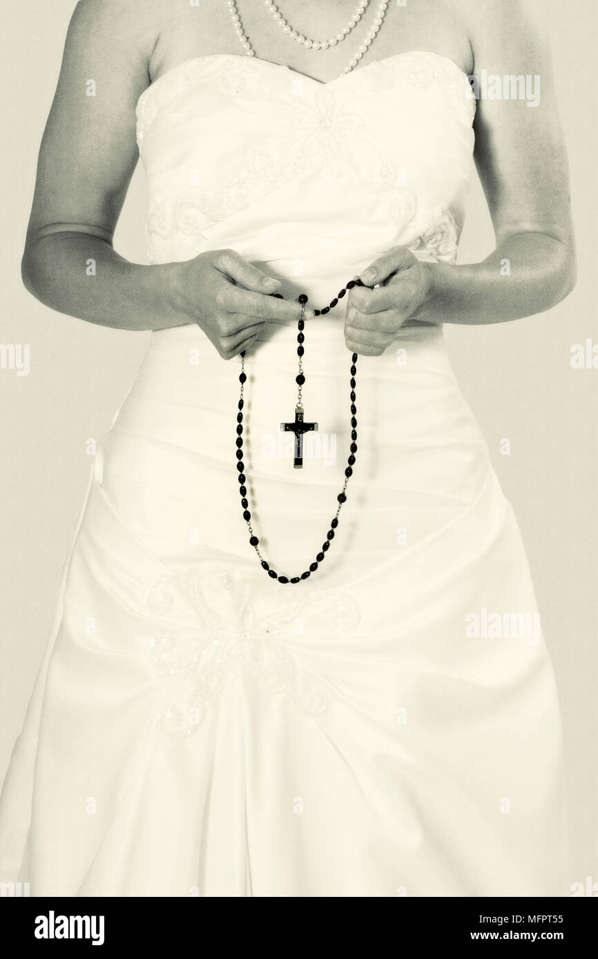 Girl holding rosary hi-res stock photography and images - Alamy