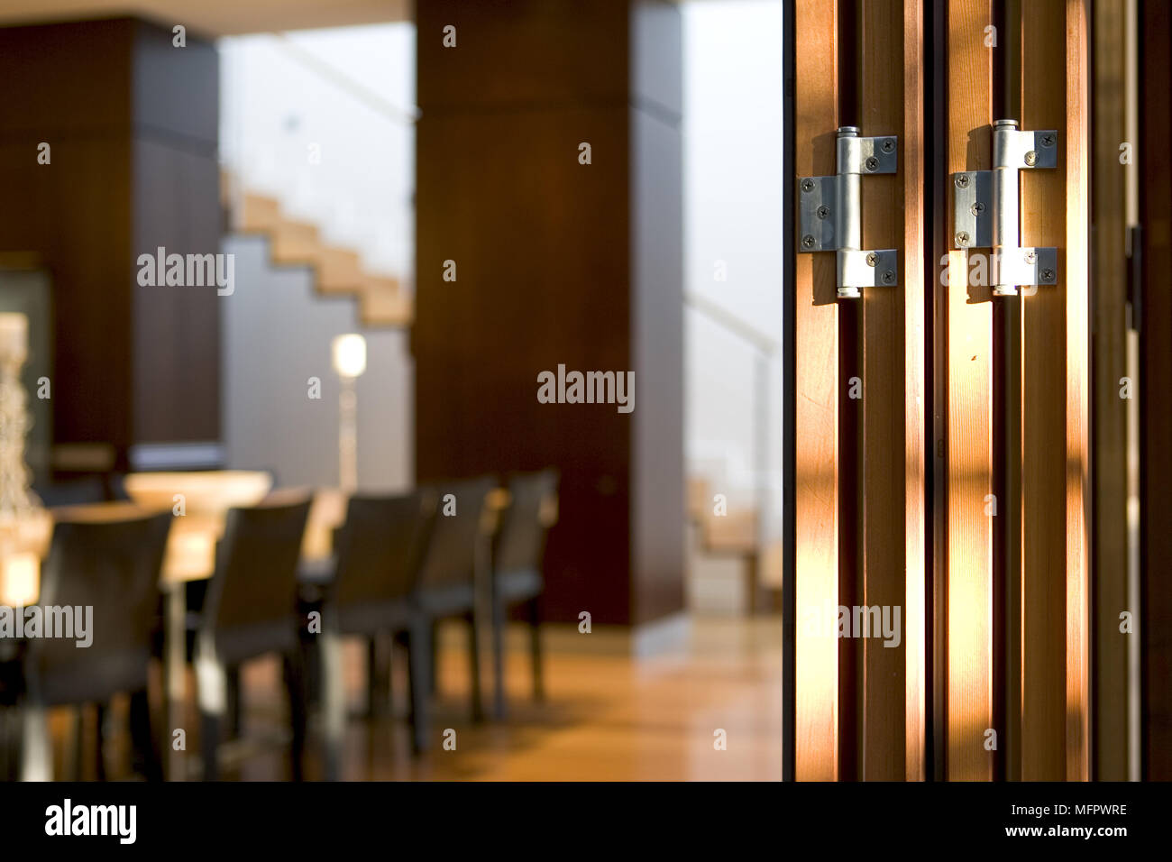 Close up of concertina patio doors with dining room beyond Stock Photo