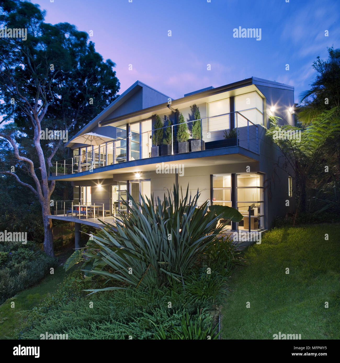 Exterior of modern house and garden seen at night Stock Photo - Alamy