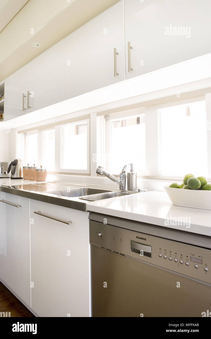 Stainless steel sink in modern kitchen with white units Stock Photo - Alamy