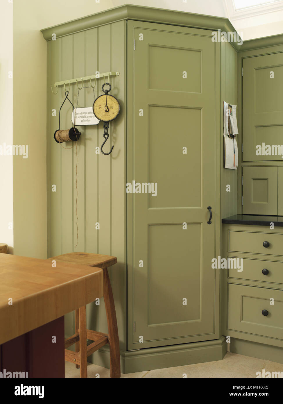 Built in green kitchen units Stock Photo - Alamy