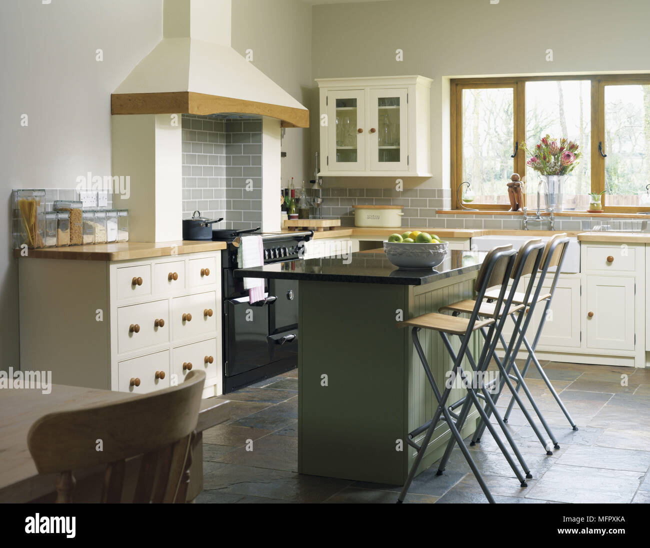Central island breakfast bar in kitchen with fitted units Stock Photo