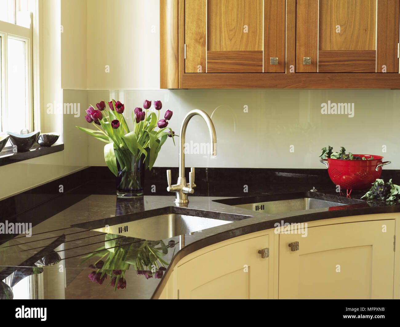 Double sink with tap fitting set in granite worktop in kitchen unit