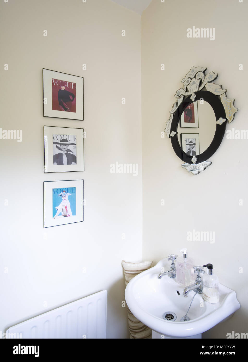 Mirror above washbasin in cloakroom Stock Photo Alamy