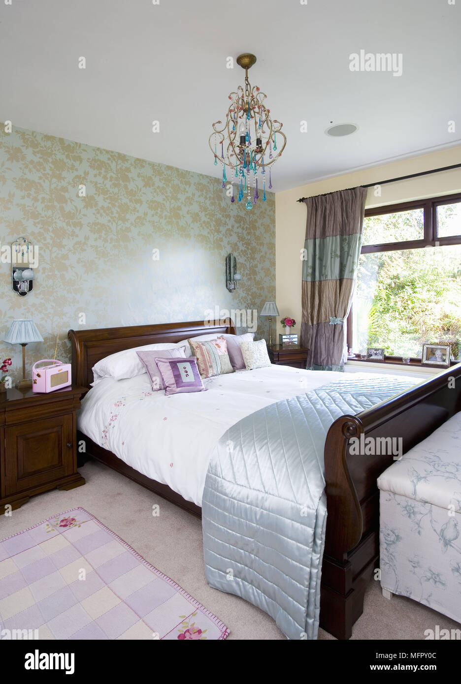 Lamp on bedside table in traditional style bedroom Stock Photo Alamy