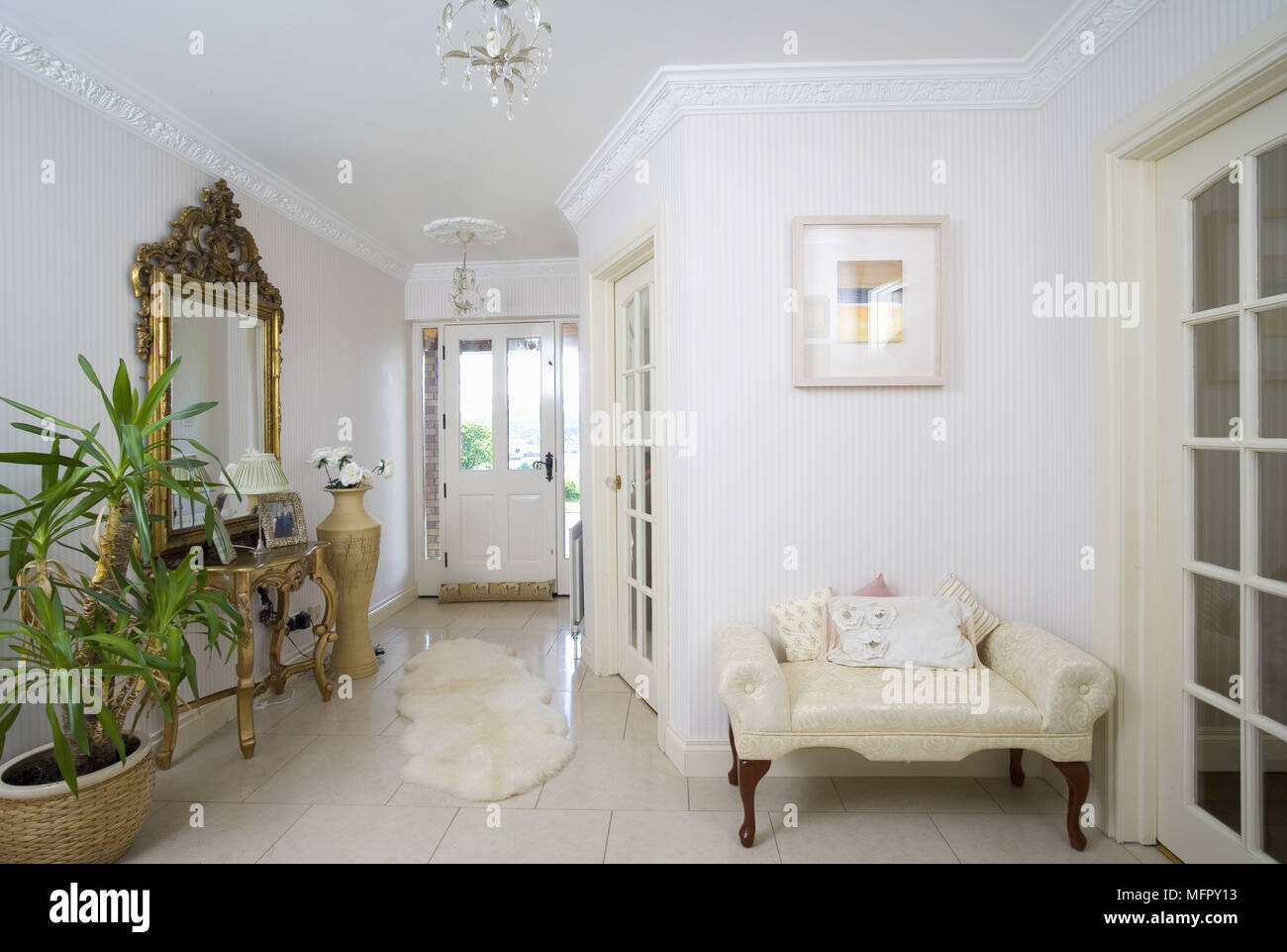 Upholstered seat in white hallway Stock Photo Alamy