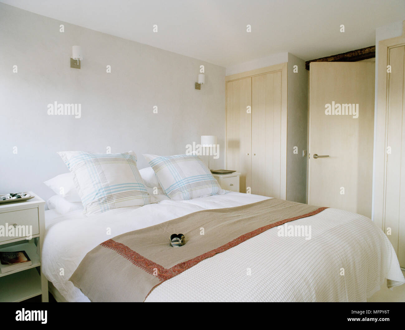 Double Bed In Modern Bedroom With Fitted Wardrobe Stock Photo