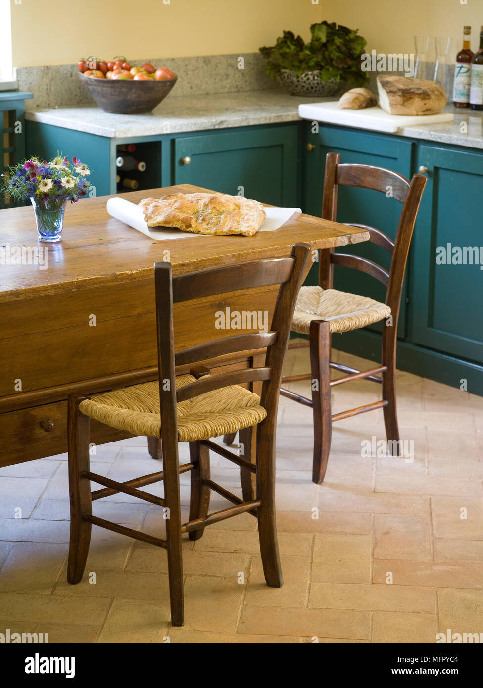 Wooden table and chairs in country style kitchen Stock Photo - Alamy