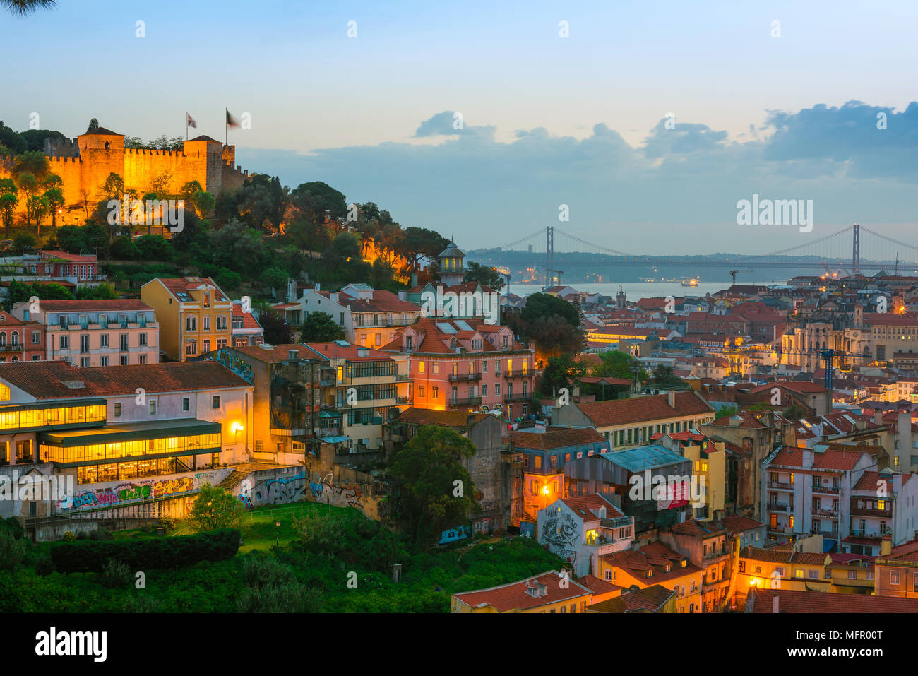Lisbon skyline, view across the rooftops of the Mouraria in the center of Lisbon towards the River Tagus and the Ponte 25 de Abril bridge, Portugal. Stock Photo