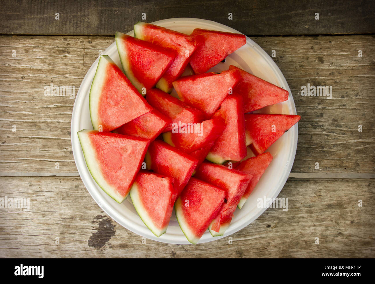 Seedless watermelon cut into wedges serving on dish Stock Photo