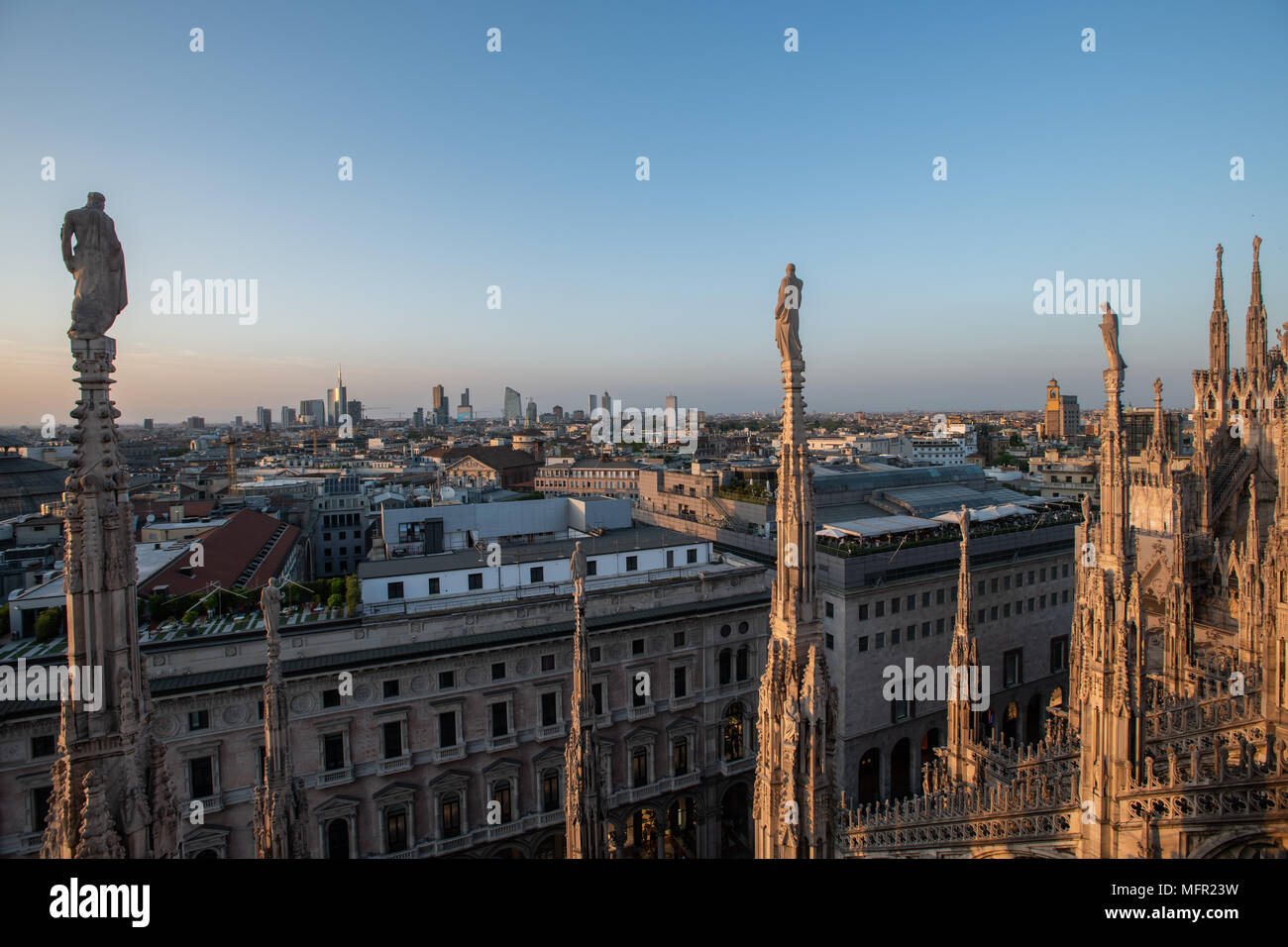 Milan, Italy - 25 April, 2018: The skyline of the city seen from the Duomo Cathedral at sunset. Stock Photo