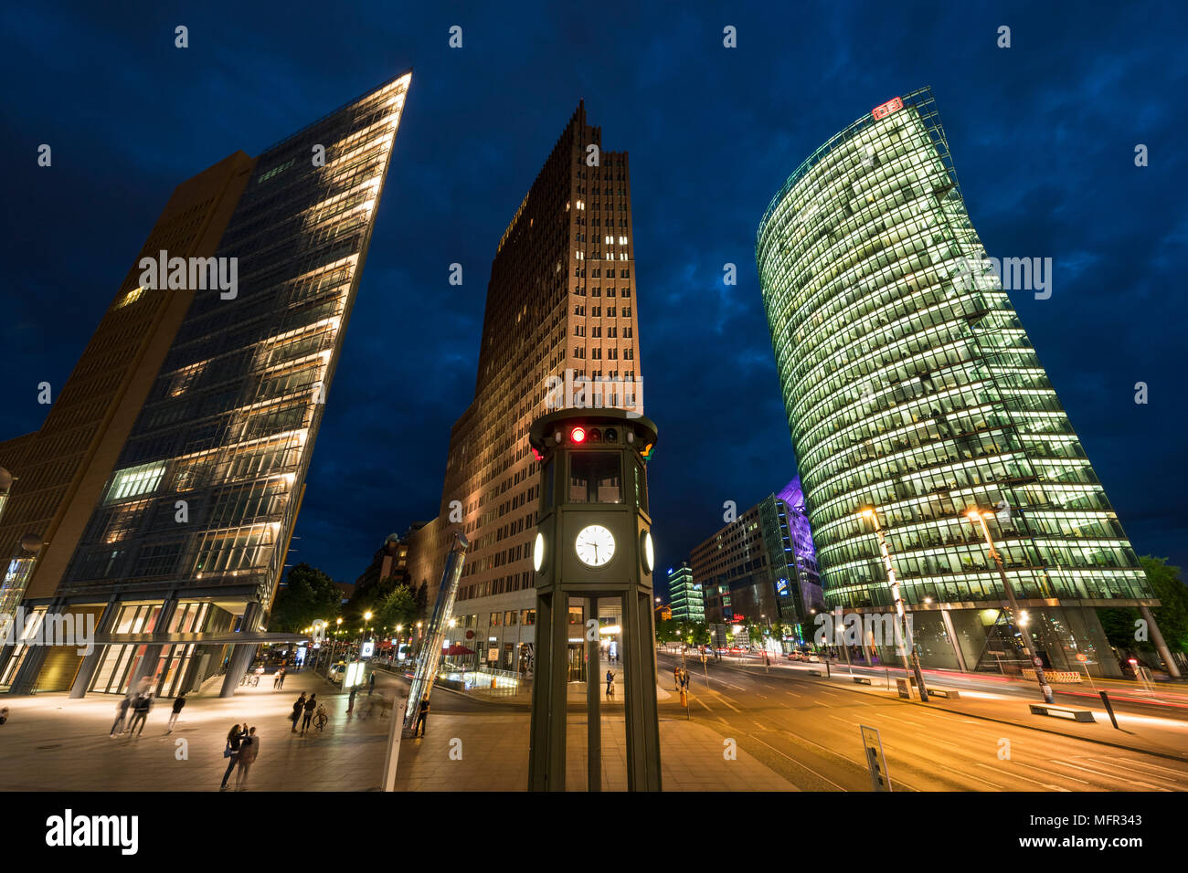 Berlin. Germany. Potsdamer Platz, night view of skyscrapers and the replica historical traffic light tower / clock, designed by Jean Krämer, and made  Stock Photo