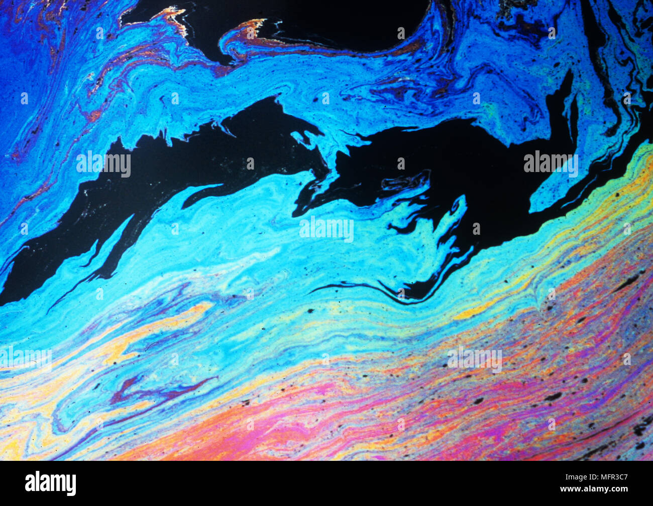Abstract in oil slick in Scalpay harbour, Isle of harris, Outer Hebrides, Scotland. Stock Photo