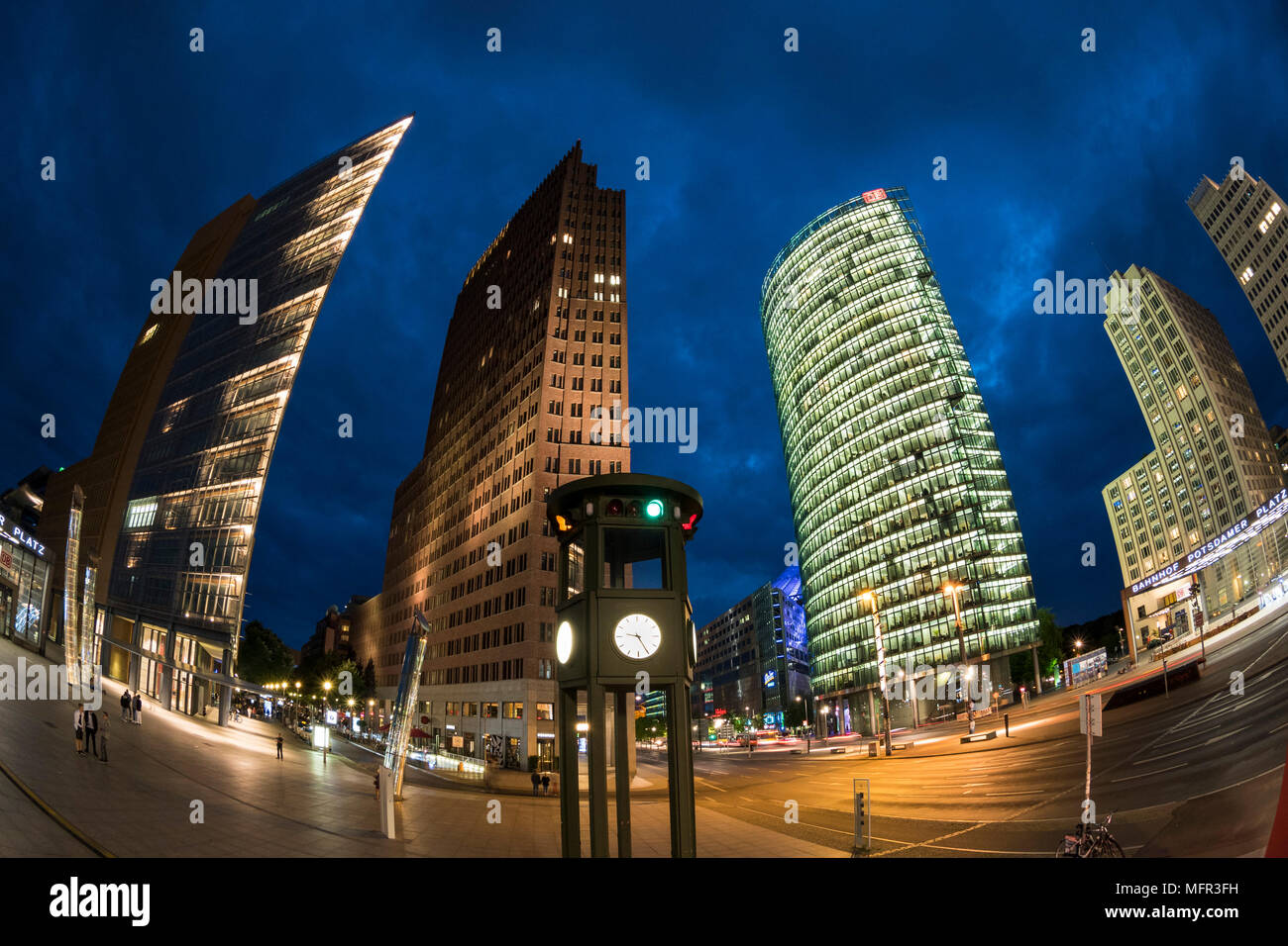 Berlin. Germany. Potsdamer Platz, fisheye night view of skyscrapers and the replica historical traffic light tower / clock, designed by Jean Krämer, a Stock Photo