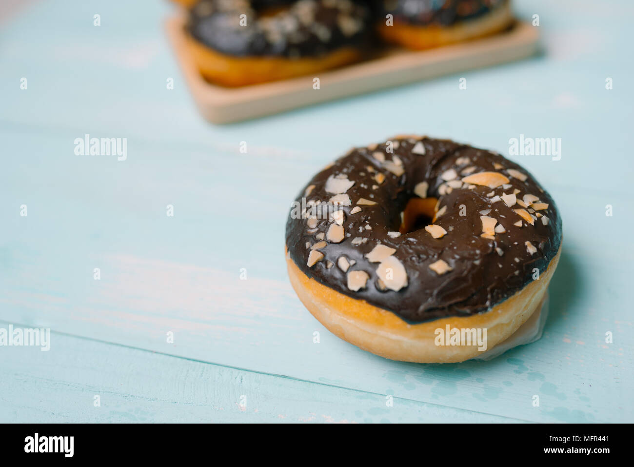 Chocolate donuts on blue background. Top view with copy space Stock ...