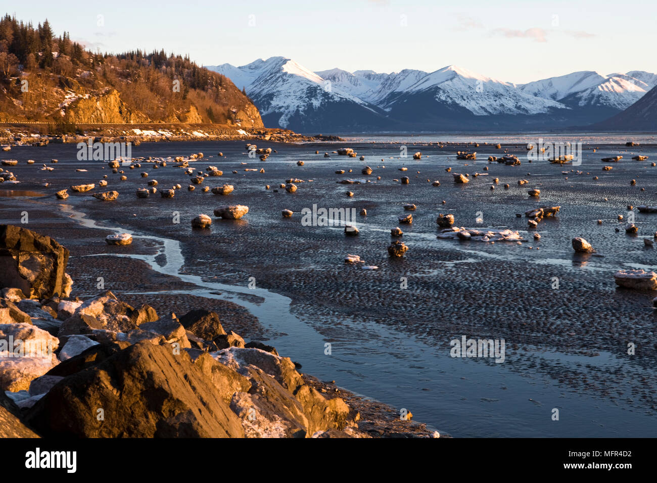 Turnagain Arm with the snow capped Kenai mountains in the distance. The low tide reveals the mud flats which are both beautiful and treacherous, as th Stock Photo