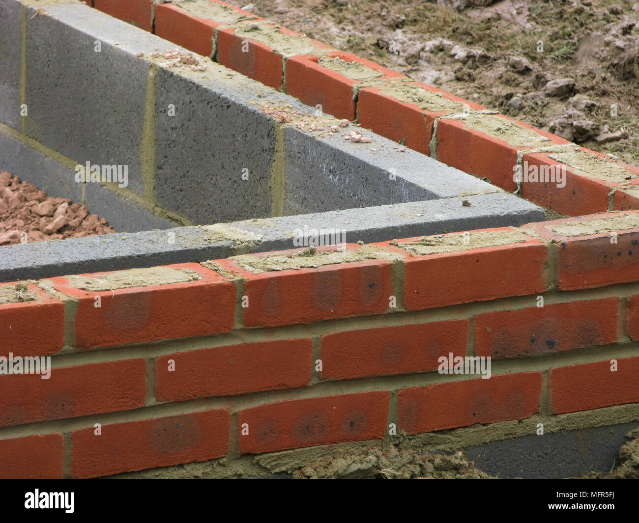 Bricks & thermalite bricks built up to the damp course in a wall Stock Photo Alamy