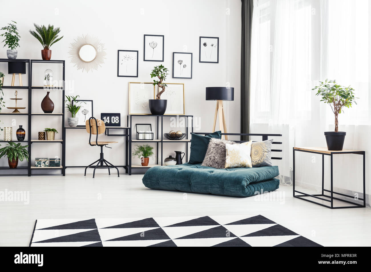 Green Folded Mattress Couch With Pillows Standing In Bright Industrial Interior With Fresh Plants And Study Corner Stock Photo Alamy